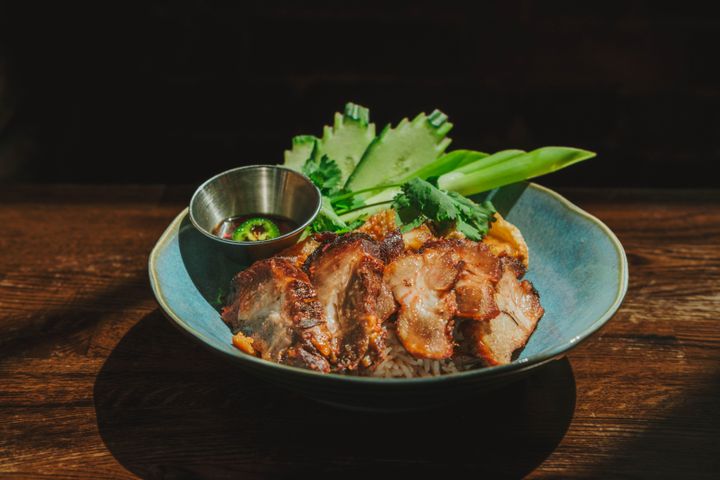 Mahaniyom signature dishes Pad Thai, Beef Massaman, Had Yai Fried Chicken, and BBQ & Crispy Pork On Rice